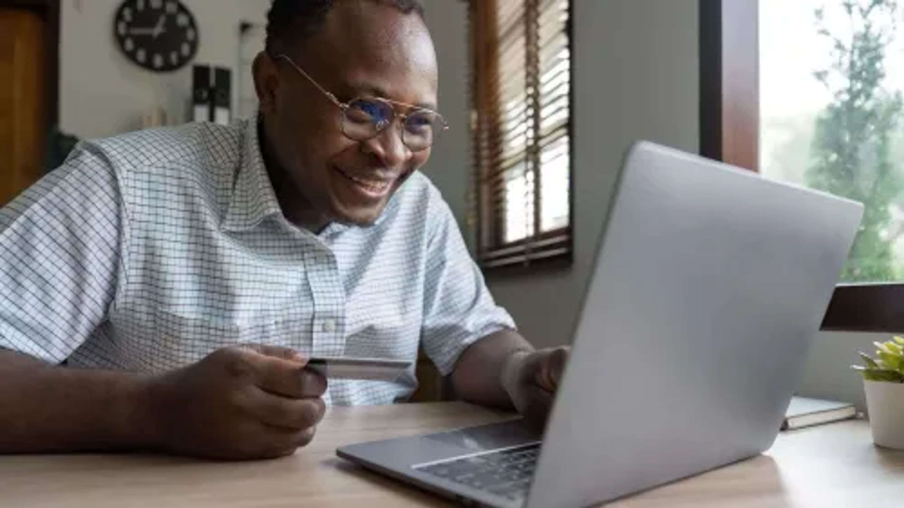 large_focal_black-man-holding-credit-card-for-online-shopping-2023-05-04-18-55-42-utc.webp